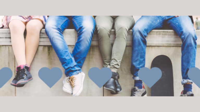Teens sitting together on a ledge, representing connection, belonging, and support for vulnerable youth through foster care ministry