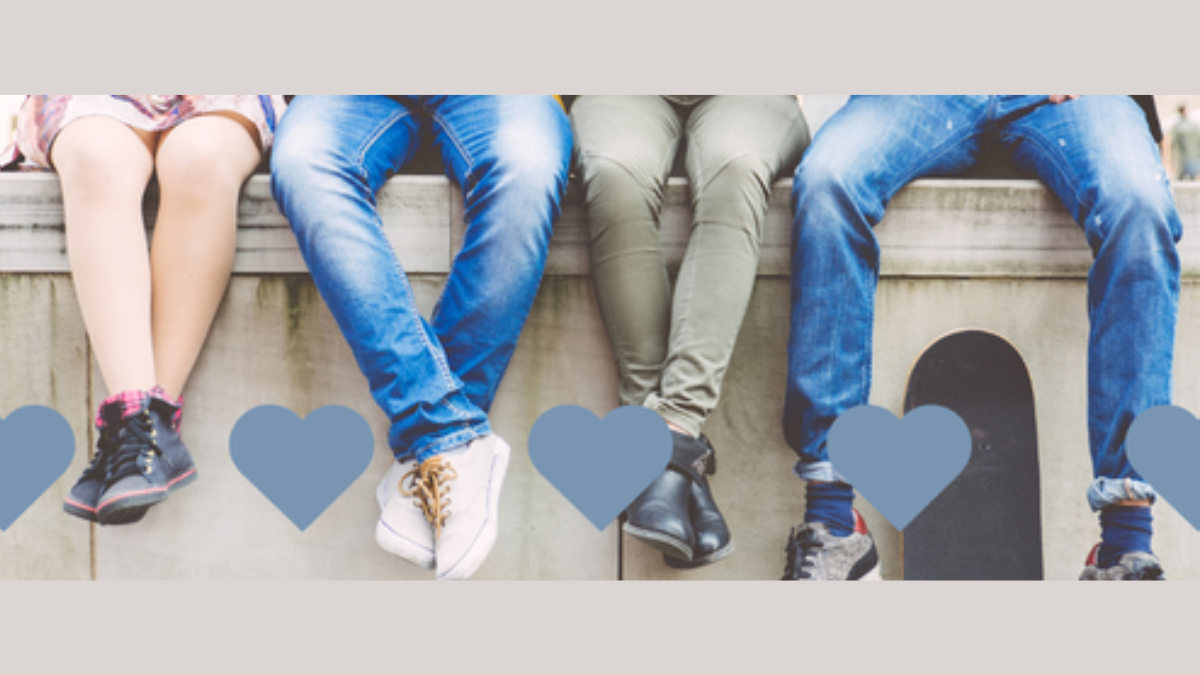 Teens sitting together on a ledge, representing connection, belonging, and support for vulnerable youth through foster care ministry